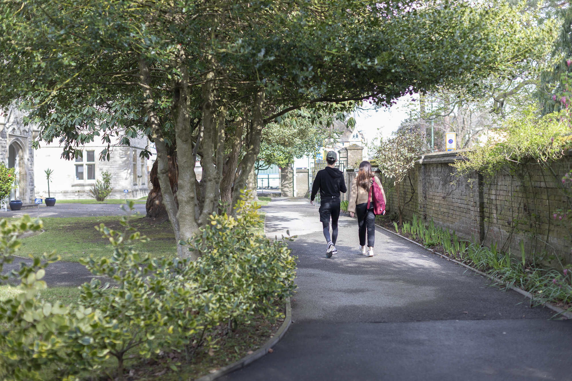 Couple of students walking around campus gardens