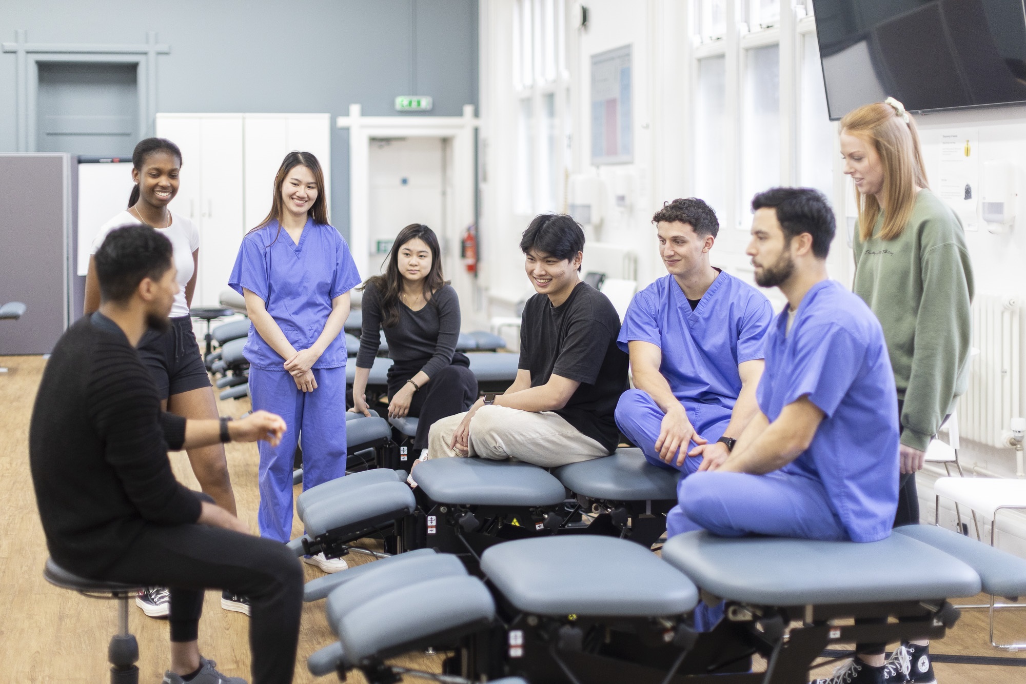 Students using chiro equipment.