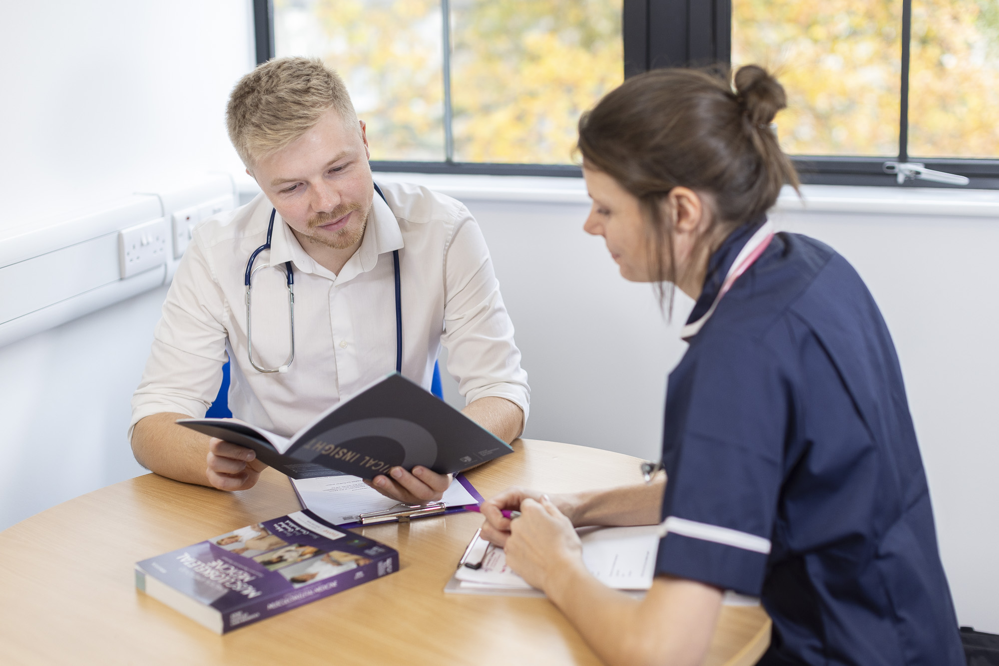 Two medical professionals having a conversation