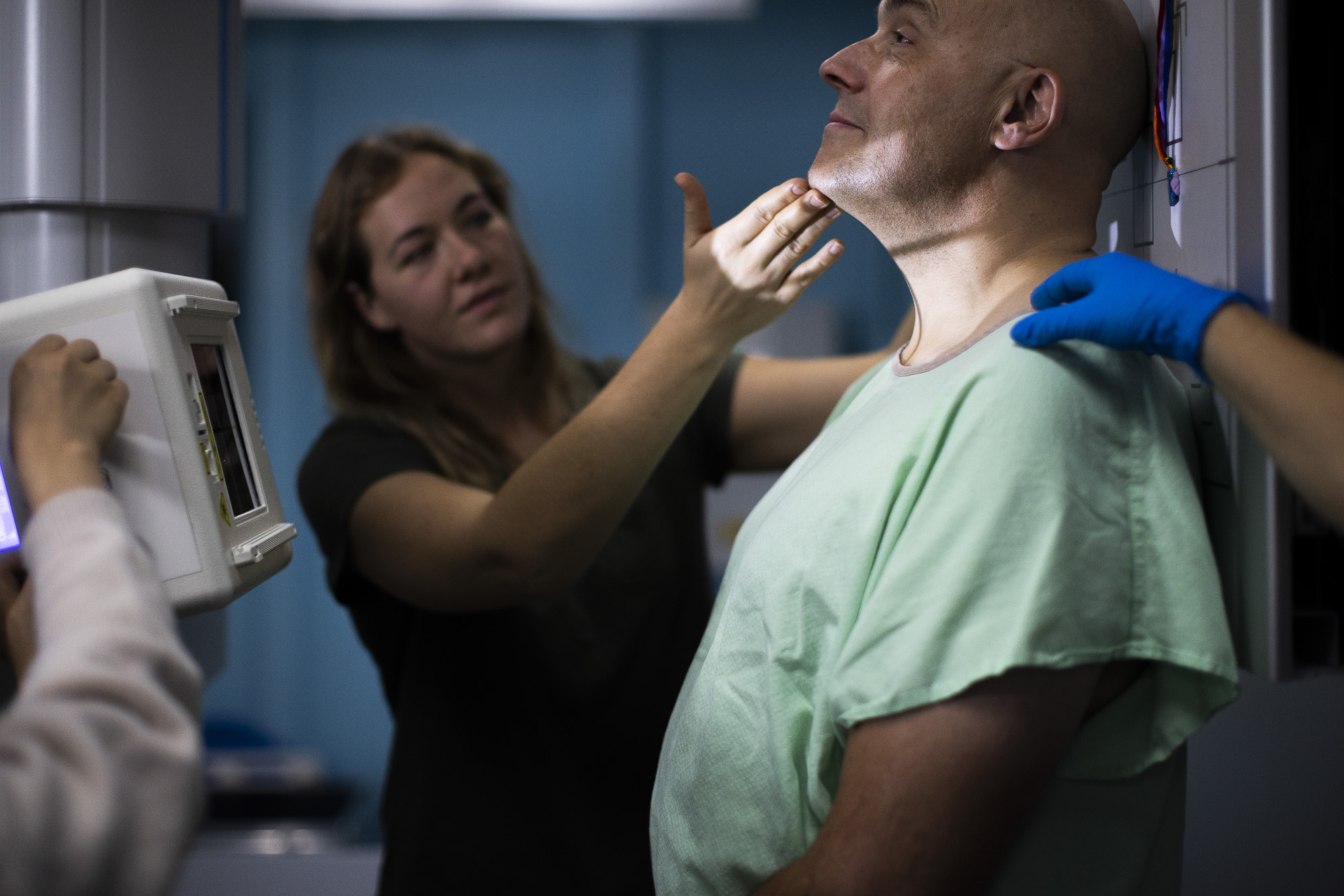 Student posing as a patient in a simulation suit