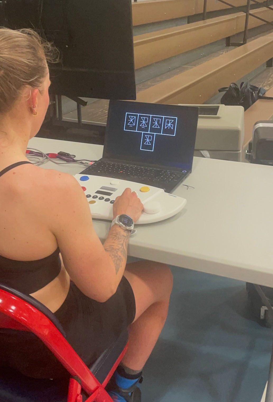 A woman uses a testing device on a table.