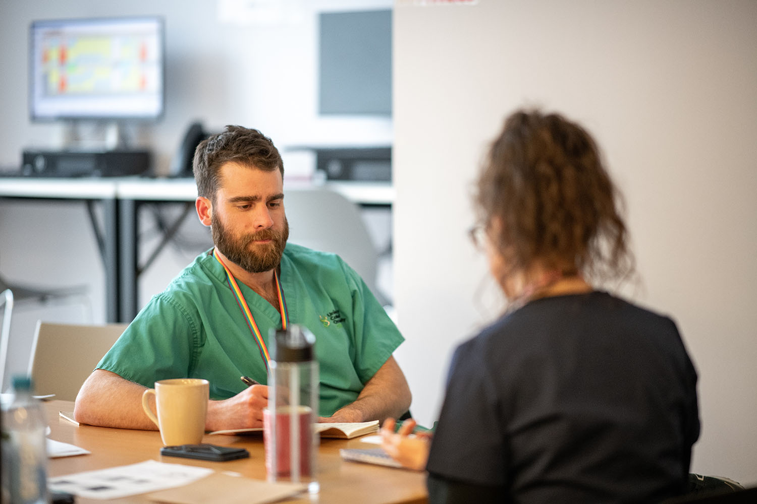 a student sits with a tutor.