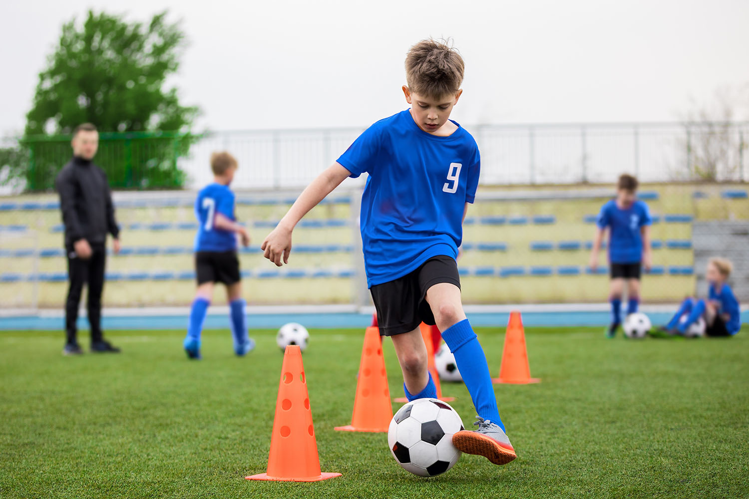 Boys attending soccer training on school field.
