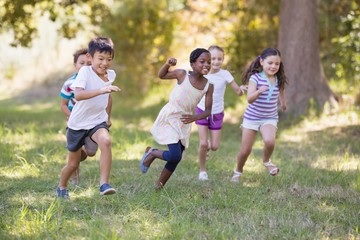 children running by trees 