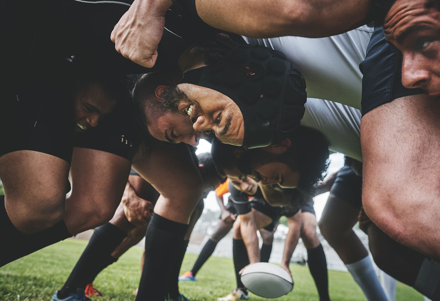rugby players in a scrum on a field during a game