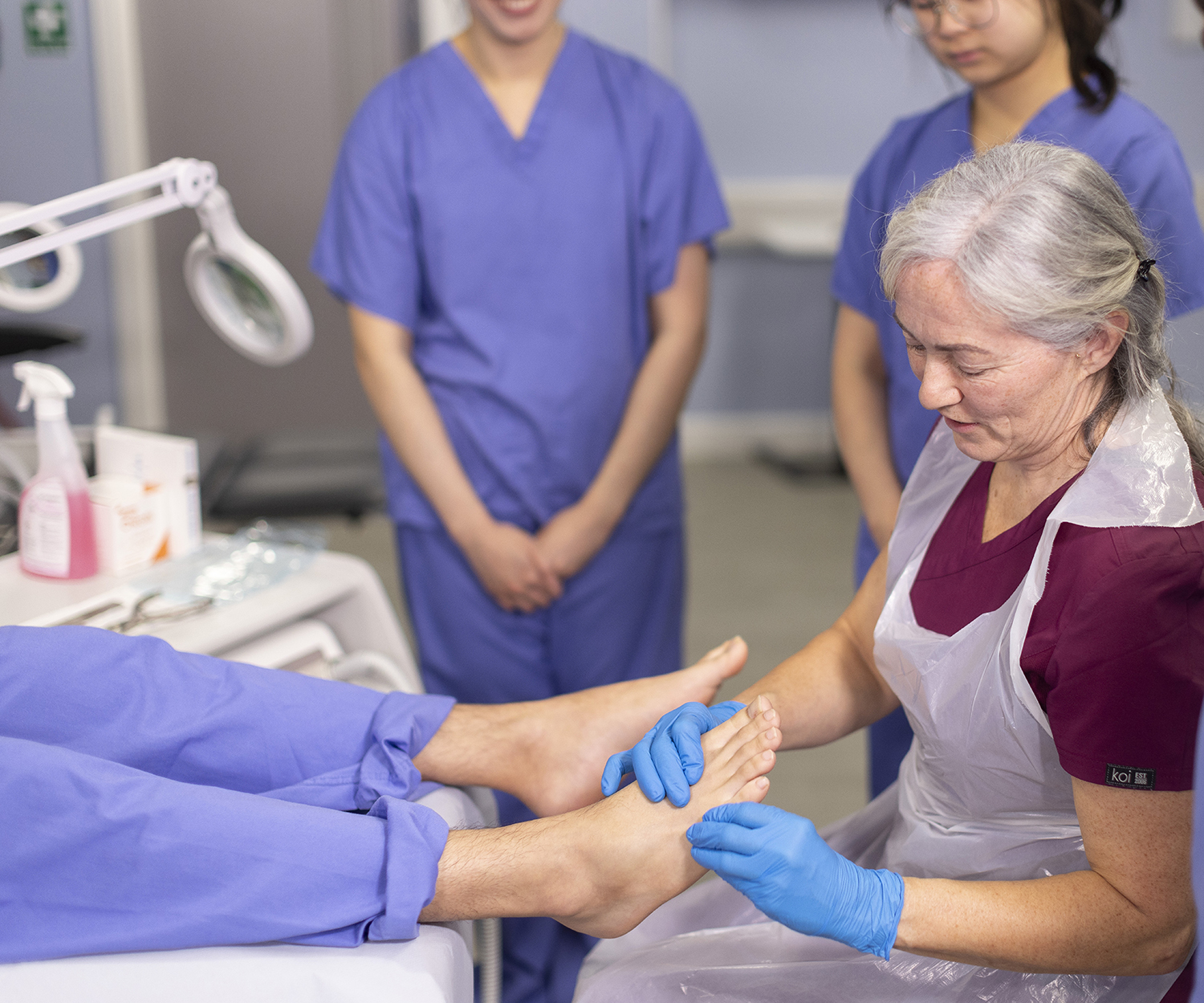 podiatry is demonstrated to a group of students.