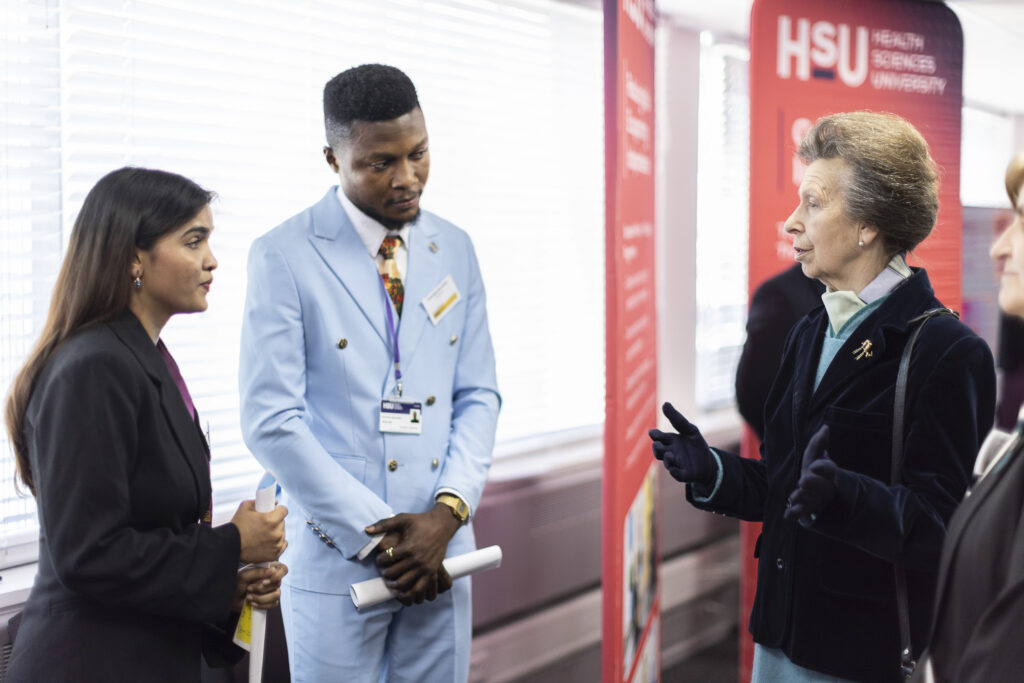 Her Royal Highness Princess Anne talks to two students from the Health Business School. 
