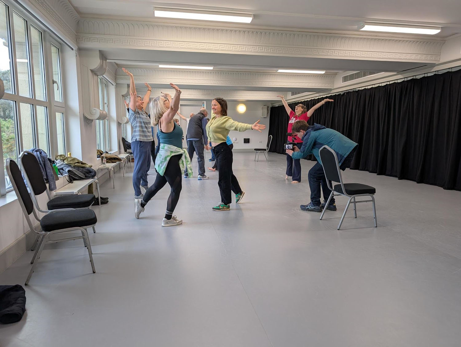 A group of women dance in a hall.