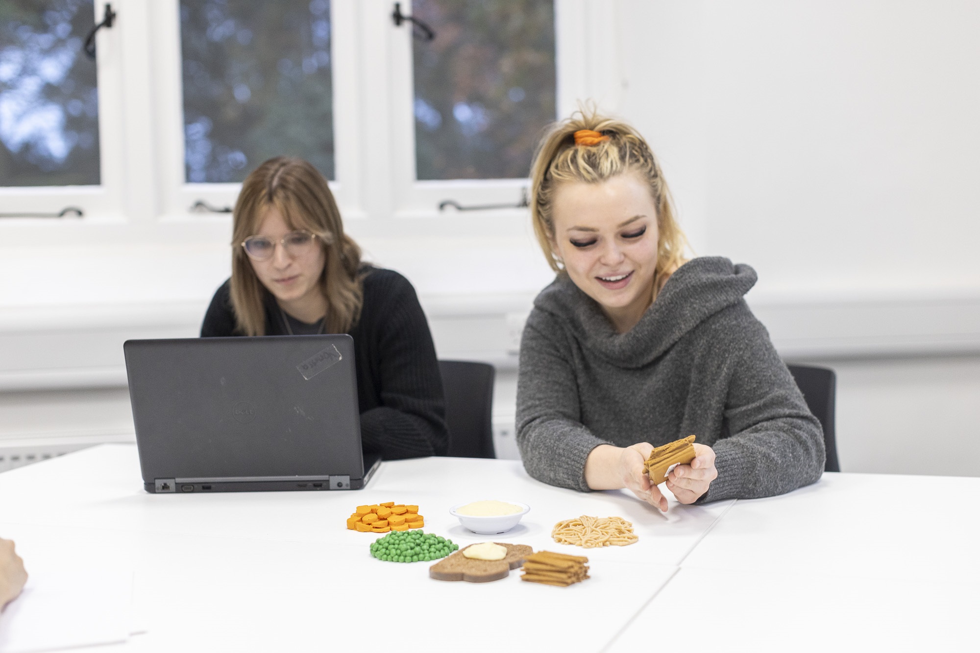 Two Students using models of food.