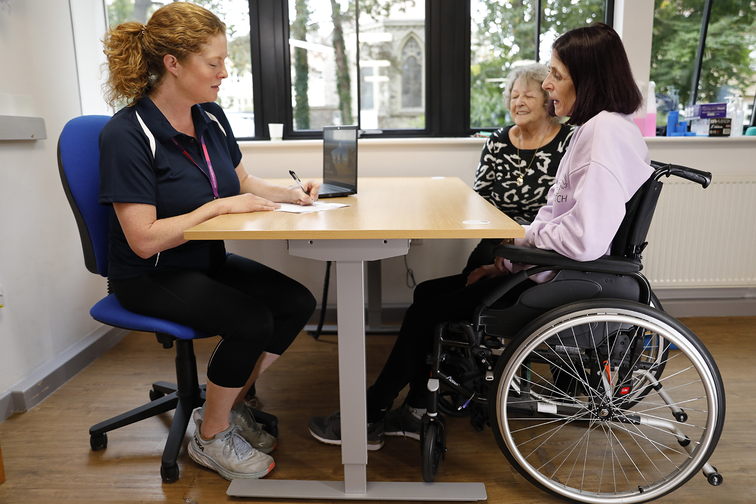 A person sits in a wheelchair